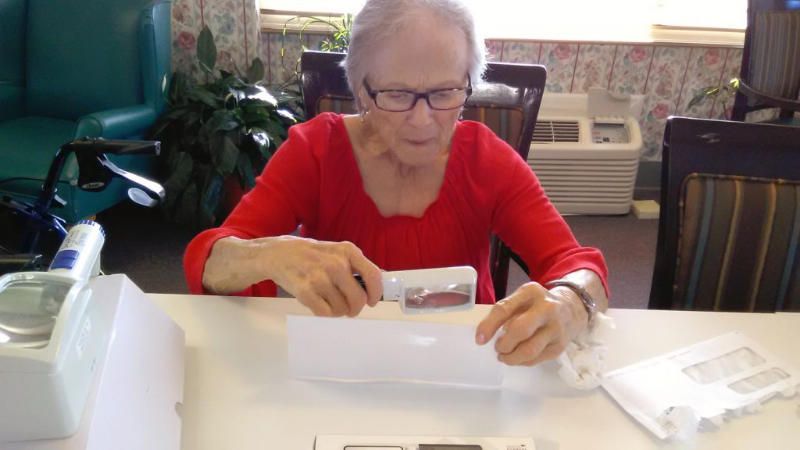 woman with low vision using a reading tool