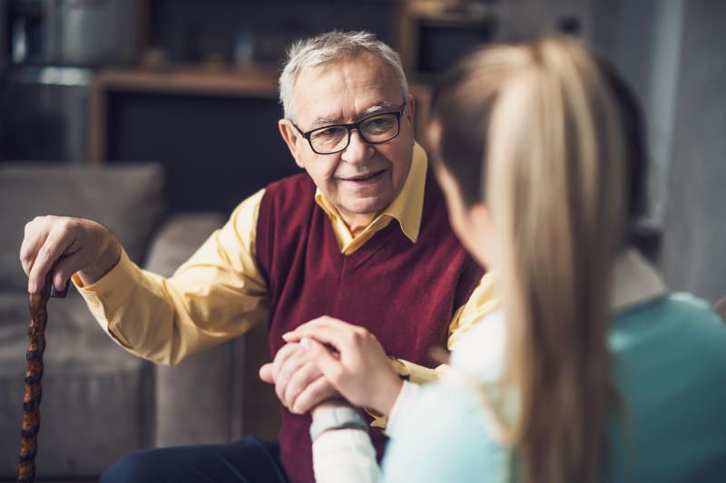 caregiver helping eldery man